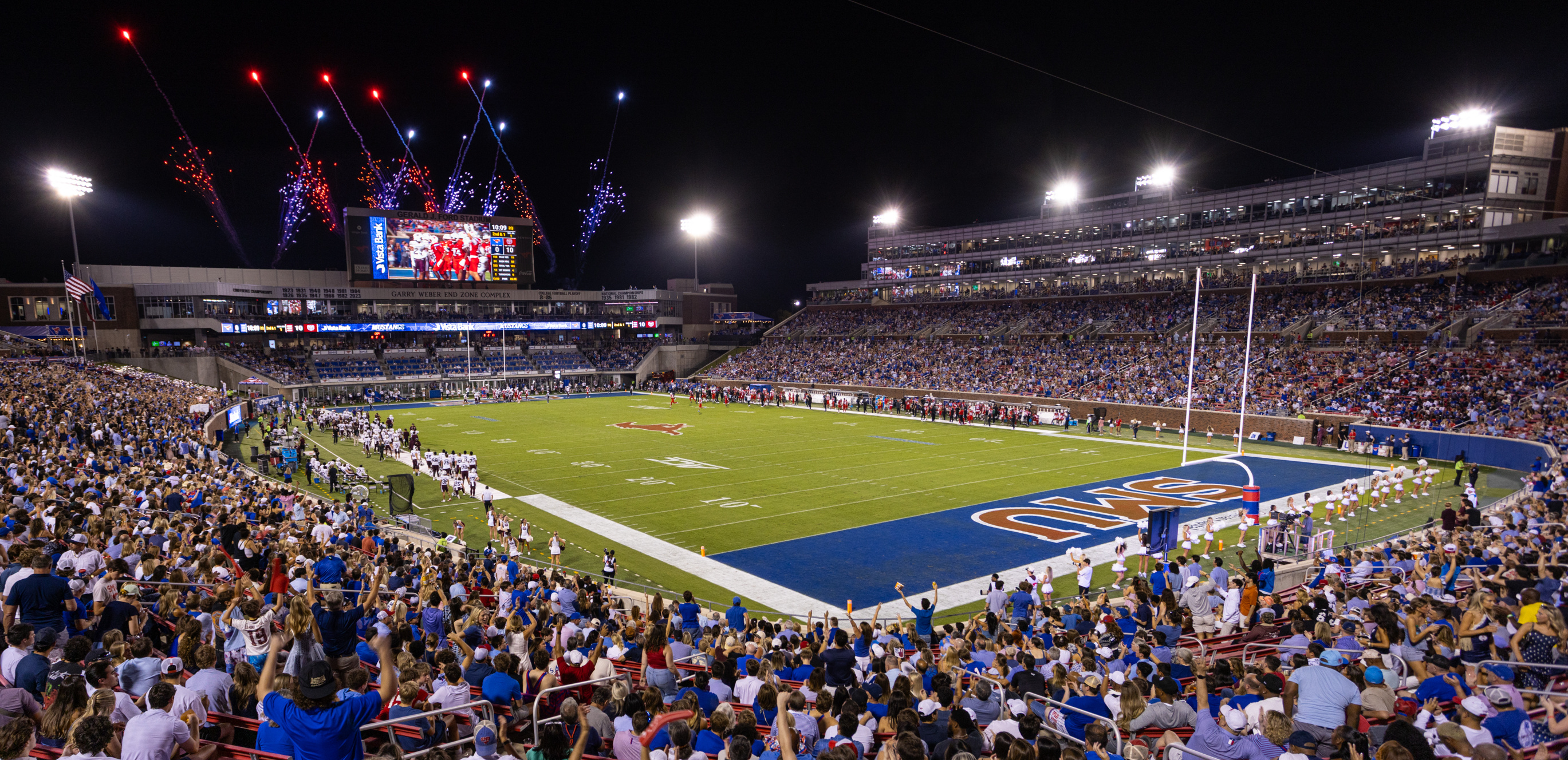 Fans cheer as Southern Methodist University scores a touchdown against Missouri State during SMU's Family Weekend.