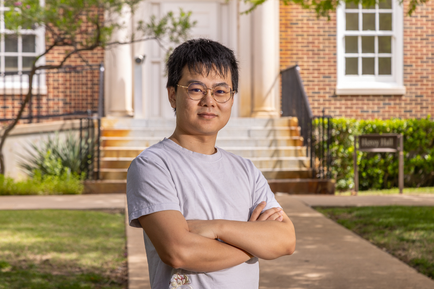Postdoctoral student Qingyu Sui stands outside N.L. Heroy Hall, for use in a news release about his research on rock glaciers.