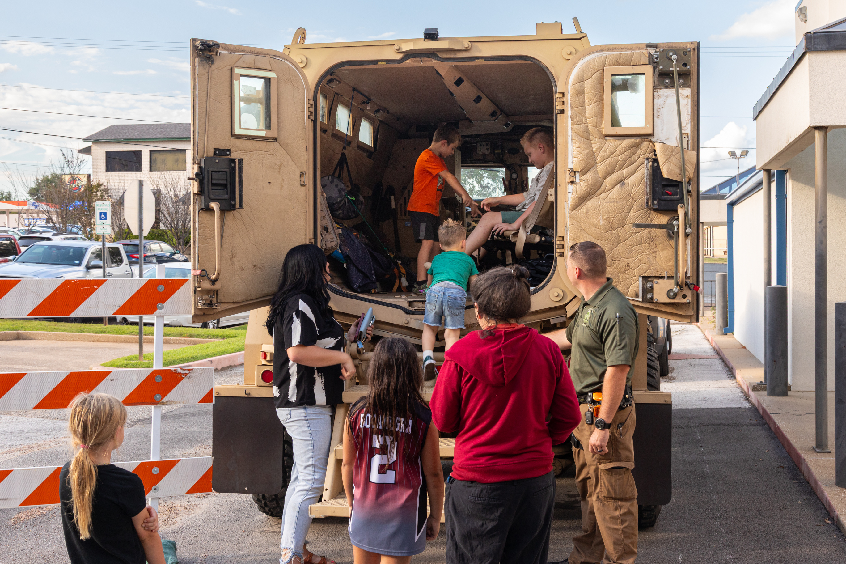 Children climb into an armored vehicle during National Night Out, an event that connects the community with members of law enforcement.